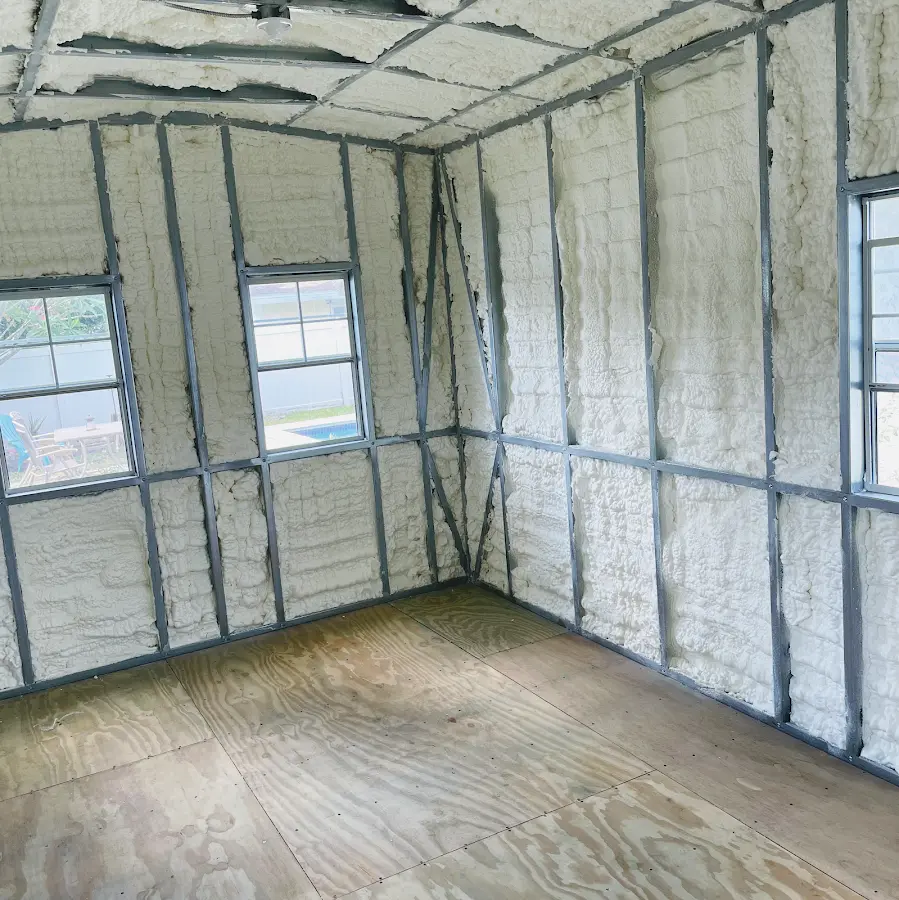 Closed-cell spray foam insulation applied to wall cavities in a residential project in Holly